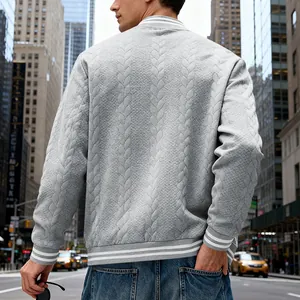 Back view of a men's grey cable-knit baseball jacket with striped ribbed hem and cuffs