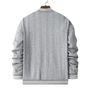 Back view of a grey men's cable knit baseball jacket with striped ribbed trims.