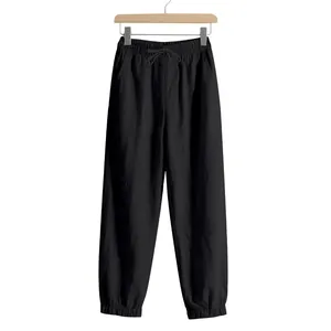 Detailed view of black linen joggers for men with an elastic waist and drawstring