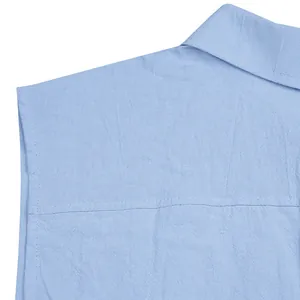 Close-up detail of light blue linen shirt fabric texture and collar stitching