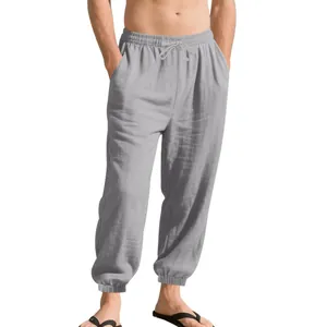 Detail of grey men's linen casual joggers with drawstring waist and elastic cuffs.