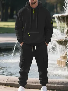 Men's oversized black fleece tracksuit set including a partial zip hoodie and cargo joggers