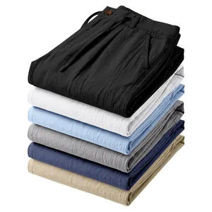 Detailed stack of multi-colored men's linen drawstring casual trousers