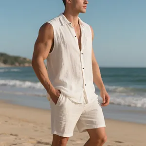 Close-up detail of a men's white sleeveless linen shirt and shorts set on beach