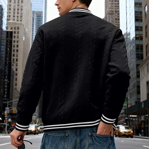 Detailed back view of a black cable-knit men's varsity jacket with striped ribbing