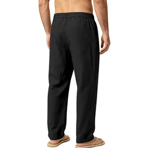 Detailed back view of men's loose black linen trousers with comfortable elastic waistband