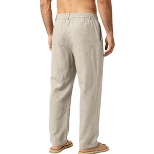 Back view of men's loose linen straight-leg trousers in beige with elastic waist