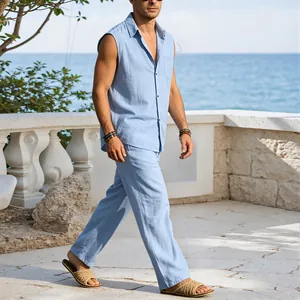 Detailed side view of a man walking in a light blue sleeveless linen shirt and trousers set