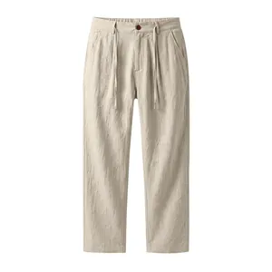 Close-up detail of beige linen men's pants with drawstring waist and straight leg