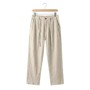 Beige men's casual linen pants with a drawstring waist and straight leg silhouette