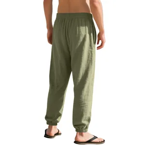 Back view of men's olive green linen jogger pants featuring elastic cuffs and waist