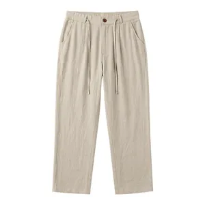 Detailed view of men's linen casual pants with drawstring waist and button closure.