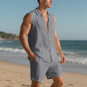 Detailed view of men's gray linen sleeveless shirt and shorts set on a beach background.