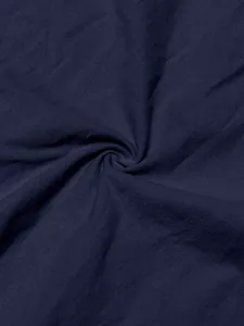 Macro view of premium navy blue linen fabric showing natural texture and soft weave detail.