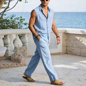 Light blue sleeveless linen shirt and pants set worn by male model on beach