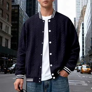 Close-up of navy blue knitted baseball jacket with cable knit texture and white buttons
