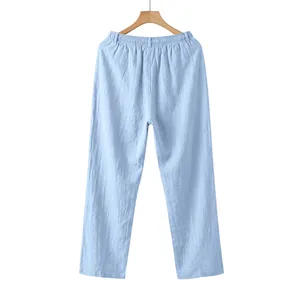Rear view of light blue men's linen casual straight trousers hanging on wooden hanger