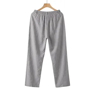 Back view of men's loose casual grey linen straight-leg trousers hanging on a wooden hanger