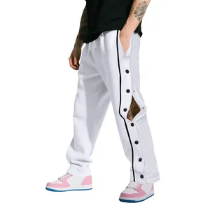 Détail du pantalon de basket hip-hop blanc lourd avec fentes latérales à boutons-pression noirs