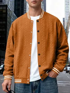 Men's orange cable-knit varsity jacket with ribbed striped trim on city street background