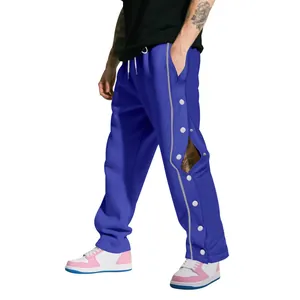 Vue détaillée du pantalon de basket bleu lourd pour homme avec boutons-pression latéraux
