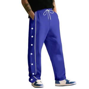 Vue détaillée du pantalon de basket bleu lourd avec boutons-pression latéraux