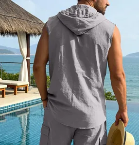 Detailed back view of a men's casual grey linen hooded sleeveless shirt by a summer pool