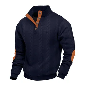Detailed macro shot of navy blue cable knit sweater with orange collar and elbow accents