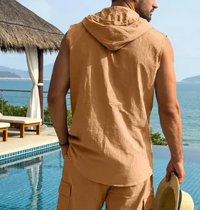 Back view of a man wearing a casual tan linen hooded sleeveless shirt and shorts set