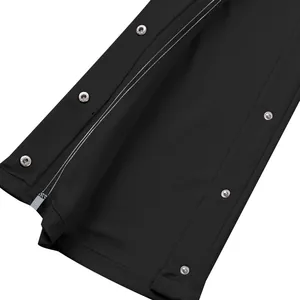 Macro vue détaillée des boutons-pression argentés sur un pantalon de basket noir