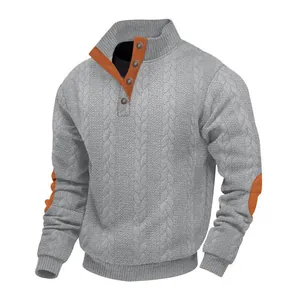 Macro detail of men's grey cable knit sweater featuring orange contrast elbow patches