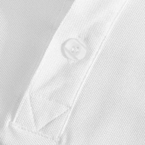 Detailed macro view of white breathable pique fabric and button on a men's polo shirt