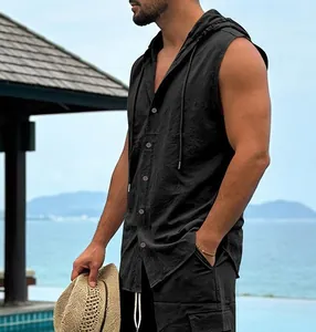 Side view of premium men's black sleeveless hooded linen shirt in a tropical beach setting