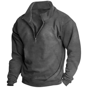 Detail of men's gray fleece sweatshirt with half-zip stand collar and ribbed cuffs.