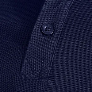 Macro detail of navy blue piqué fabric and button placket on breathable Polo shirt
