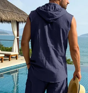 Back view of men's navy blue hooded sleeveless linen shirt in a resort setting