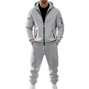 Grauer Fleece-Trainingsanzug für Herren mit Kapuze und orangefarbenen Reißverschlüssen.