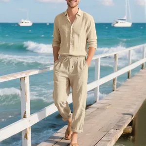 Close-up view of men's beige linen shirt and pants set worn on a sunny wooden beach pier
