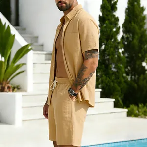 Outdoor lifestyle shot showing a man in a yellow striped linen shirt and matching shorts