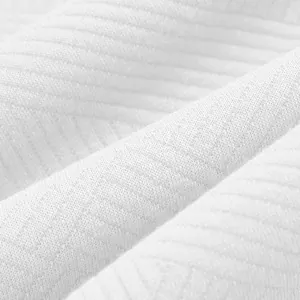 Macro view of high-quality white jacquard fabric texture for men's heavyweight sweatshirt.