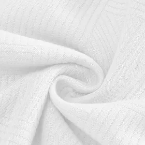Close-up of premium white heavyweight jacquard fabric showing intricate geometric texture