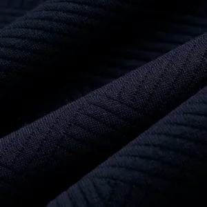 Detailed close-up view of premium heavyweight navy blue jacquard knit fabric texture