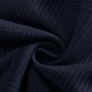 Macro detail showing the rich texture of dark navy jacquard fabric for retro sweatshirt