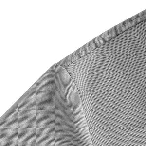 Macro view of breathable grey fabric and durable stitching detail on men's polo shirt