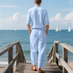 Rear view of men's breathable light blue linen shirt and pants set on a seaside pier