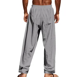 Detailed back view of men's loose grey linen trousers for casual leisure and beach wear