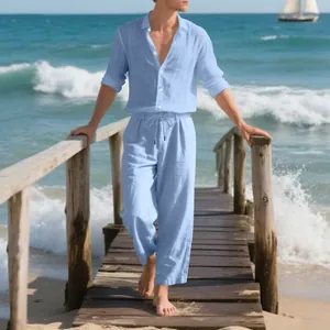 Men's breathable light blue linen long sleeve shirt and trousers set on a sunny beach