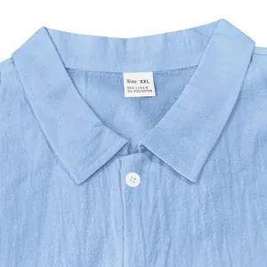 Detail of a light blue men's linen shirt collar featuring the XXL size label and fabric