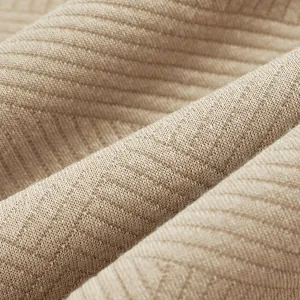 Close-up of heavyweight jacquard knit fabric showing intricate diagonal texture