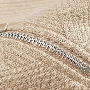 Close-up of heavy jacquard fabric texture and silver metal zipper detail